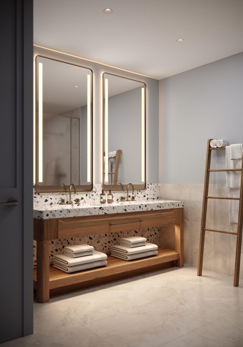 A modern bathroom features a double sink vanity with wooden accents, large illuminated mirrors, neatly folded towels on shelves and a wooden ladder holding additional towels against a light-colored wall.