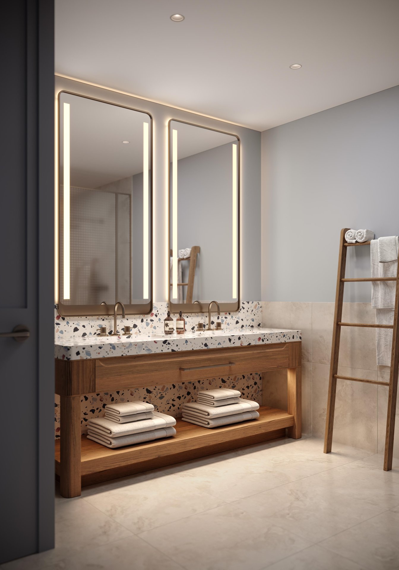 A modern bathroom features a double sink vanity with wooden accents, large illuminated mirrors, neatly folded towels on shelves and a wooden ladder holding additional towels against a light-colored wall.