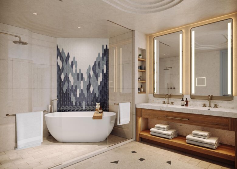 Modern bathroom with a freestanding white tub, geometric blue tile accent wall, glass shower, double sink vanity with large mirrors and lighting, wooden shelves, and folded towels neatly arranged.