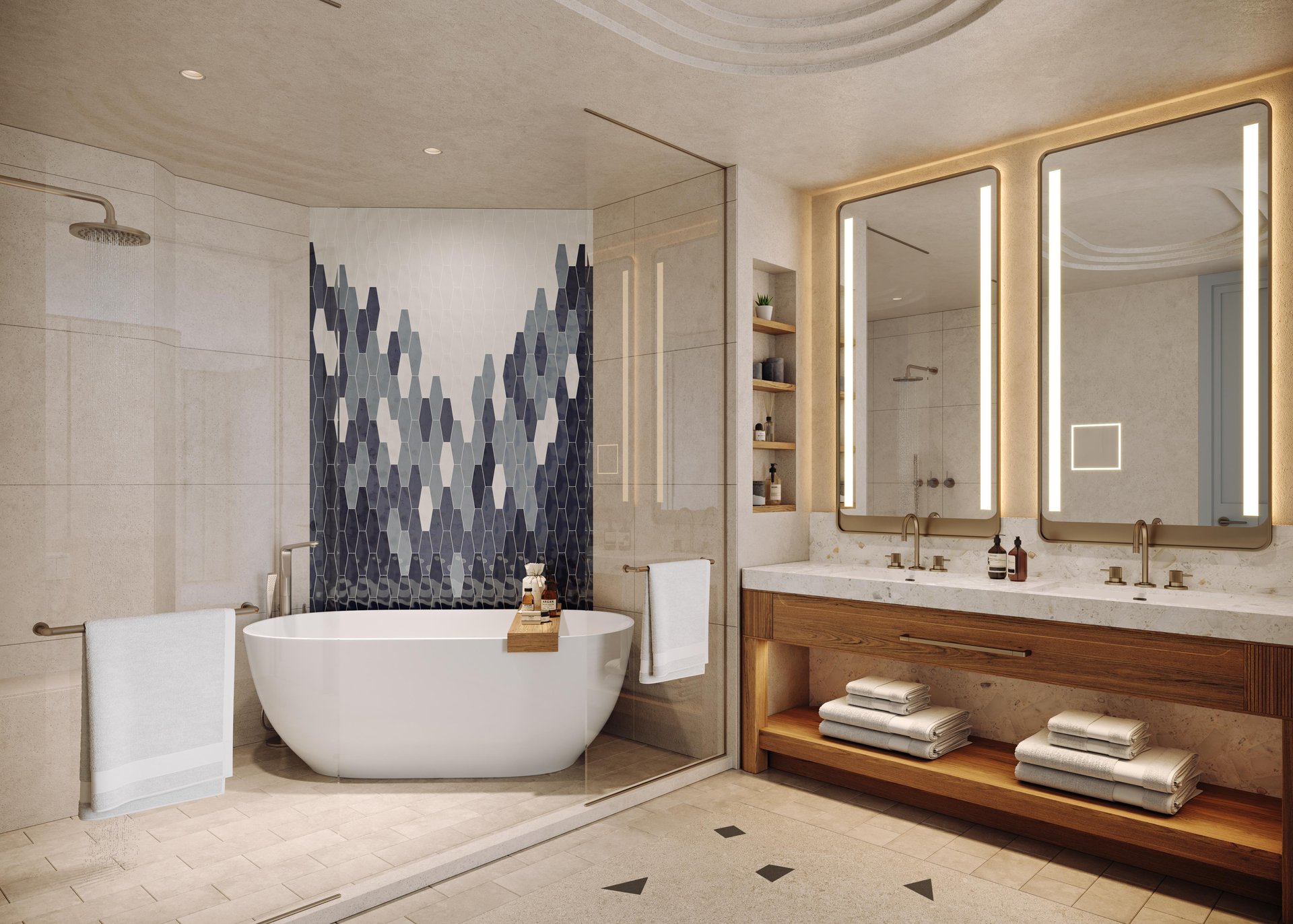 Modern bathroom with a freestanding white tub, geometric blue tile accent wall, glass shower, double sink vanity with large mirrors and lighting, wooden shelves, and folded towels neatly arranged.